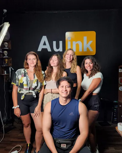 Clients and artist inside the AU Ink tattoo studio