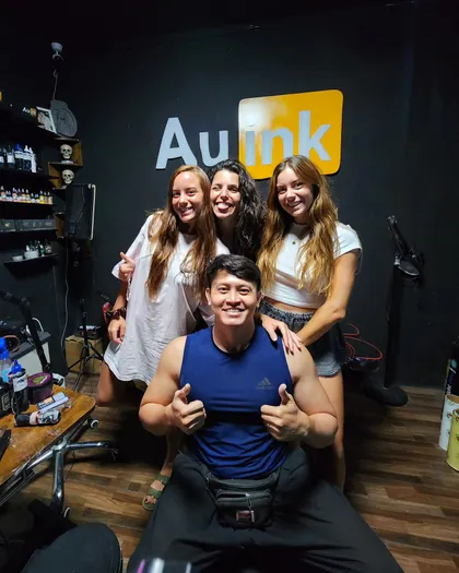 Clients and artist inside the AU Ink tattoo studio