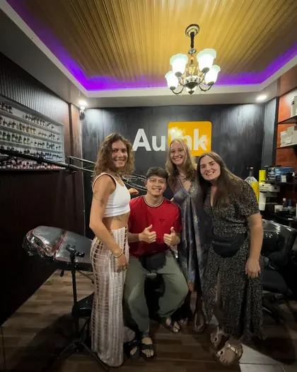 Clients and artist inside the AU Ink tattoo studio