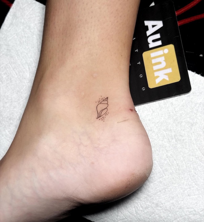 Shell, island-inspired tattoo by Aurelio Dinorog III