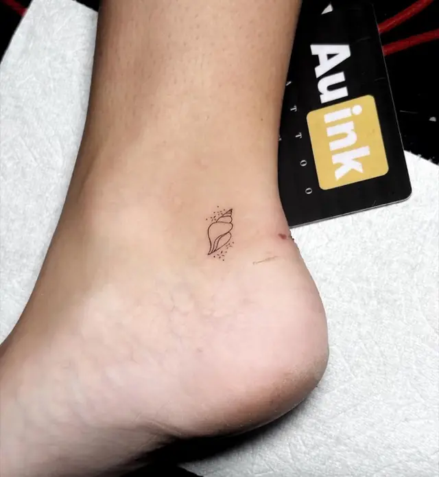 Shell, island-inspired tattoo by Aurelio Dinorog III