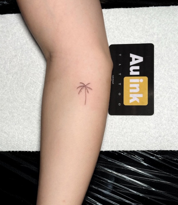Palm tree, island-inspired tattoo by Aurelio Dinorog III