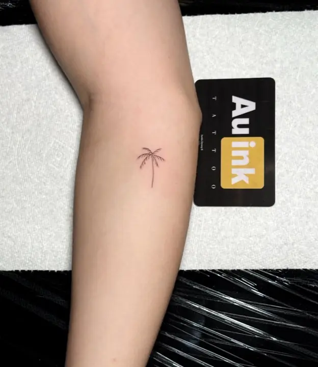 Palm tree, island-inspired tattoo by Aurelio Dinorog III
