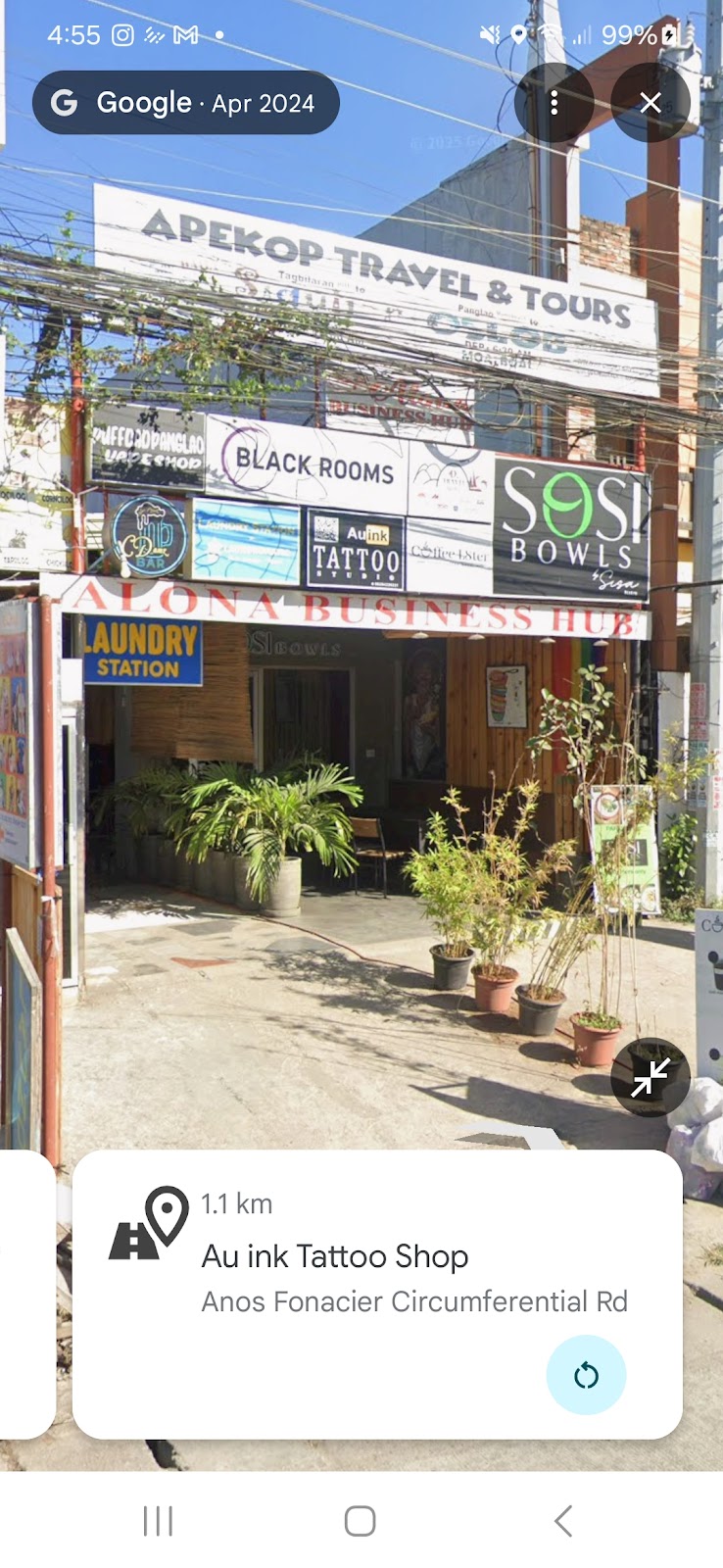 Exterior of Alona Business Hub with the AU Ink Tattoo sign visible